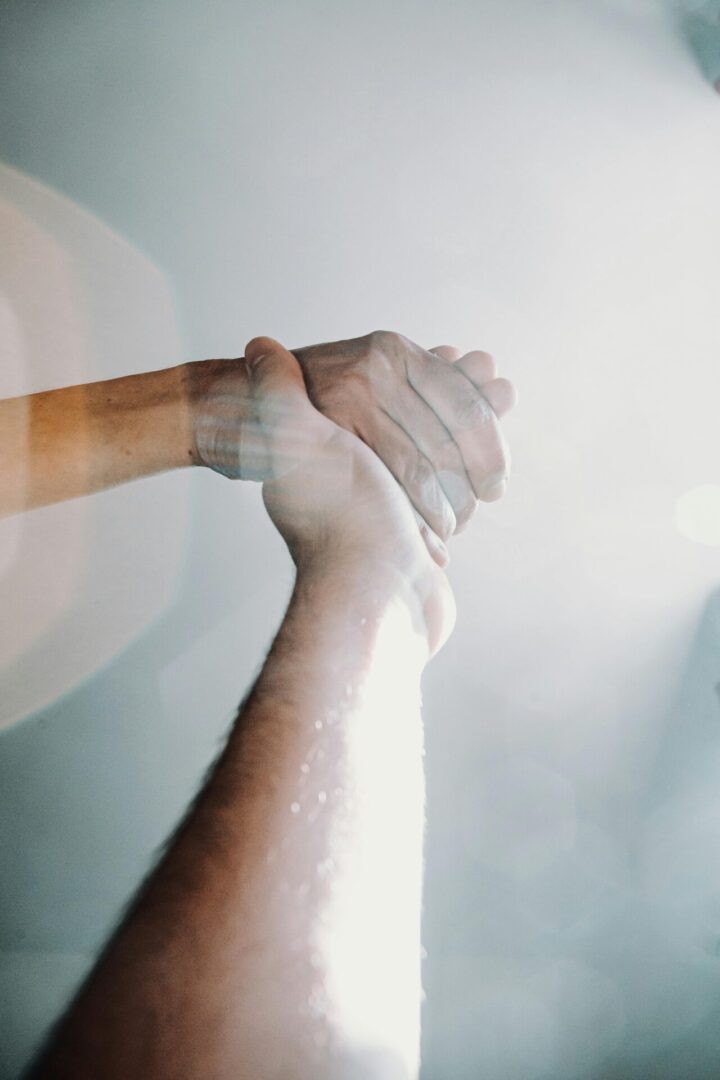 Two hands holding each other in a circle.