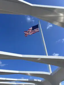 A flag flying on top of a pole in the sky.